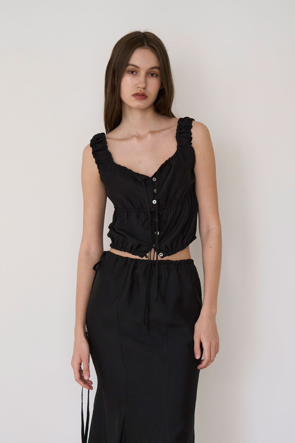 oesoel-ss-24-pearl-button-sleeveless-blouse-black