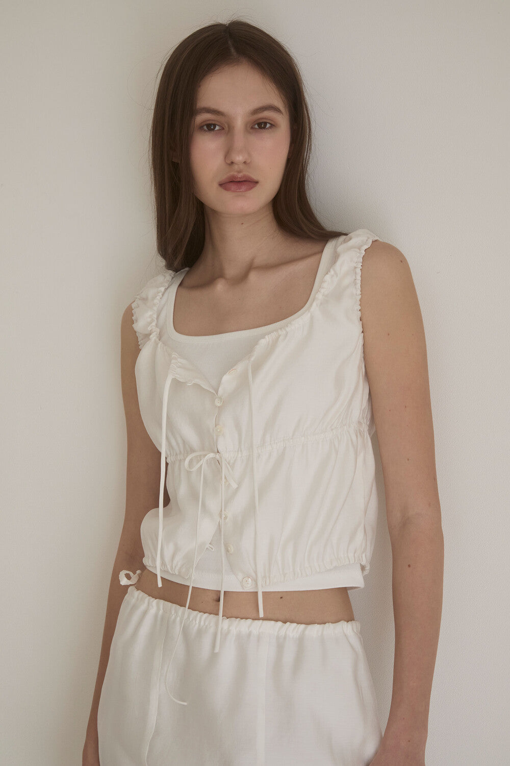 oesoel-ss-24-pearl-button-sleeveless-blouse-white